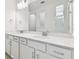 Modern bathroom with double vanity, quartz countertop and chrome fixtures at 13806 Sunlight Meadow Dr, Riverview, FL 33578