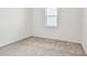 Simple bedroom with neutral wall and carpet at 13806 Sunlight Meadow Dr, Riverview, FL 33578