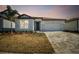 House exterior featuring a two-car garage and landscaping at 13806 Sunlight Meadow Dr, Riverview, FL 33578