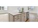 Kitchen island with white cabinets and quartz countertop at 13806 Sunlight Meadow Dr, Riverview, FL 33578