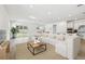 Bright living room featuring a large sectional sofa and sliding glass doors leading to the backyard at 13806 Sunlight Meadow Dr, Riverview, FL 33578