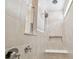 Walk-in shower with tiled walls and built-in seat at 13806 Sunlight Meadow Dr, Riverview, FL 33578