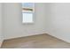 Simple bedroom with wood-look flooring and a window at 13808 Sunlight Meadow Dr, Riverview, FL 33578