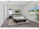 Bright bedroom with gray bedding and large windows at 13808 Sunlight Meadow Dr, Riverview, FL 33578