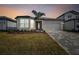 House exterior showcasing a two car garage and front yard landscaping at 13808 Sunlight Meadow Dr, Riverview, FL 33578