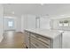 Light gray kitchen island with white countertop in an open floor plan at 13808 Sunlight Meadow Dr, Riverview, FL 33578