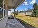 Back patio with pavers, overlooking a grassy backyard at 13808 Sunlight Meadow Dr, Riverview, FL 33578