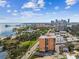 Drone view showcasing a high-rise building near the bay and cityscape at 1120 N Shore Ne Dr # 703, St Petersburg, FL 33701