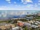 Aerial view of waterfront property, tennis courts, and a tropical landscape at 1120 N Shore Ne Dr # 703, St Petersburg, FL 33701