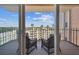 Private balcony with seating and scenic views of palm trees and buildings at 1120 N Shore Ne Dr # 703, St Petersburg, FL 33701