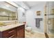 Updated bathroom with granite countertop vanity, large mirror and a glass shower at 1120 N Shore Ne Dr # 703, St Petersburg, FL 33701