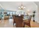 Bright dining room with glass-top table and wicker chairs, offering a view of the living room and balcony at 1120 N Shore Ne Dr # 703, St Petersburg, FL 33701