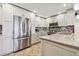 Well-equipped kitchen boasting stainless steel refrigerator and granite countertops at 1120 N Shore Ne Dr # 703, St Petersburg, FL 33701