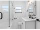 Updated bathroom with a glass shower, white vanity, and modern fixtures at 2906 W Braddock St, Tampa, FL 33607