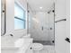 Modern bathroom with a glass shower, marble vanity, and white fixtures at 2906 W Braddock St, Tampa, FL 33607