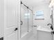 Clean bathroom with a glass shower, white bathtub, and a marble vanity at 2906 W Braddock St, Tampa, FL 33607