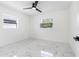 Bright bedroom featuring white walls, marble flooring, and a ceiling fan at 2906 W Braddock St, Tampa, FL 33607