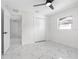 Spacious bedroom with white walls, marble floors, and a double door closet at 2906 W Braddock St, Tampa, FL 33607