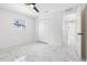 Spacious bedroom with white walls, marble floors, and a double door closet at 2906 W Braddock St, Tampa, FL 33607