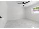 Well-lit bedroom with white walls, marble floors, and a ceiling fan at 2906 W Braddock St, Tampa, FL 33607