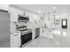 Modern white kitchen with stainless steel appliances and marble countertops at 2906 W Braddock St, Tampa, FL 33607