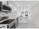 Modern kitchen with white cabinets, stainless steel appliances and marble countertops at 2906 W Braddock St, Tampa, FL 33607