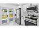 Modern white kitchen with stainless steel appliances and marble countertops at 2906 W Braddock St, Tampa, FL 33607