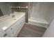 Bathroom featuring a tub/shower combo, a vanity with storage, and wood flooring at 3280 Southfield Ln # 804, Sarasota, FL 34239