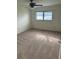 Bedroom featuring neutral carpet, a window with blinds, and an overhead ceiling fan at 3280 Southfield Ln # 804, Sarasota, FL 34239