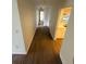 Long hallway with wood-like floor at 3280 Southfield Ln # 804, Sarasota, FL 34239