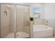 Spa-like bathroom with a large walk-in shower and soaking tub at 3948 Mossy Limb Ct, Palmetto, FL 34221