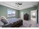 Main bedroom with large window, ceiling fan and view of the dining room at 3948 Mossy Limb Ct, Palmetto, FL 34221