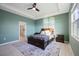 Spacious bedroom with a ceiling fan, ensuite bathroom and large window at 3948 Mossy Limb Ct, Palmetto, FL 34221