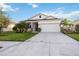 White one-story house with a two-car garage and nicely landscaped front yard at 3948 Mossy Limb Ct, Palmetto, FL 34221