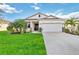 Curb appeal abounds in this charming one-story home, showcasing a well-manicured lawn and inviting facade at 3948 Mossy Limb Ct, Palmetto, FL 34221