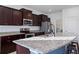 Modern kitchen with dark wood cabinets, granite countertops, and stainless steel appliances at 3948 Mossy Limb Ct, Palmetto, FL 34221