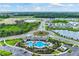 Aerial view of community with lake, pool, and homes at 6223 Distant Haze Pl, Palmetto, FL 34221