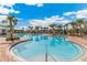 Resort-style community pool with palm trees and lounge chairs at 6223 Distant Haze Pl, Palmetto, FL 34221