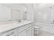 Bright bathroom boasts a white vanity, bathtub, and shower at 13810 Sunlight Meadow Dr, Riverview, FL 33578