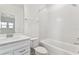 Clean bathroom with white vanity, bathtub, and toilet at 13810 Sunlight Meadow Dr, Riverview, FL 33578