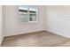 Bright bedroom with wood-look flooring and large window at 13810 Sunlight Meadow Dr, Riverview, FL 33578