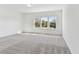 Spacious bedroom with gray carpeting and three windows at 13810 Sunlight Meadow Dr, Riverview, FL 33578
