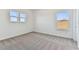 Bright bedroom with gray carpet and two windows at 13810 Sunlight Meadow Dr, Riverview, FL 33578