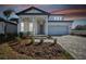 Two-story home with a welcoming front porch and landscaping at 13810 Sunlight Meadow Dr, Riverview, FL 33578