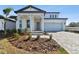 Two-story home with front yard landscaping and a two-car garage at 13810 Sunlight Meadow Dr, Riverview, FL 33578