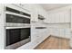 Modern kitchen with white cabinets and stainless steel appliances at 13810 Sunlight Meadow Dr, Riverview, FL 33578