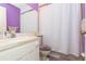 Bathroom with purple walls, white vanity, and shower at 4027 Davit Dr, New Port Richey, FL 34652