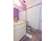 Bathroom with purple walls, white vanity, and shower/tub at 4027 Davit Dr, New Port Richey, FL 34652