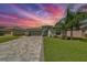 One-story house with paver driveway and landscaped lawn at 5429 Rainwood Meadows Dr, Apollo Beach, FL 33572