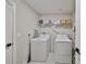 Bright laundry room with washer, dryer, and shelving at 5429 Rainwood Meadows Dr, Apollo Beach, FL 33572